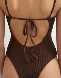 Model wearing Cooper square neck swimsuit in chocolate
