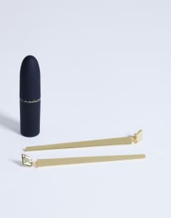 Model wearing Cora asymmetric drop stud earring in gold tone