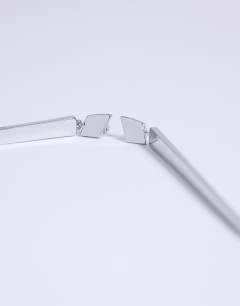 Model wearing Cora asymmetric drop stud earring in silver tone