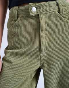 Model wearing Cord high rise barrel leg trouser in green