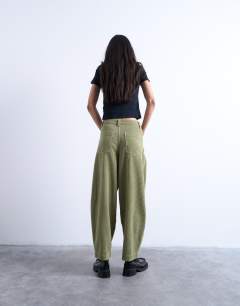 Model wearing Cord high rise barrel leg trouser in green