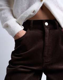 Model wearing Cord high rise barrel trouser in brown