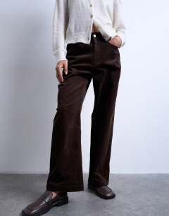 Model wearing Cord high rise barrel trouser in brown