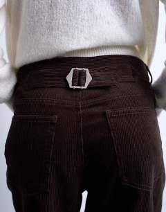 Model wearing Cord high rise barrel trouser in brown