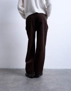 Model wearing Cord high rise barrel trouser in brown