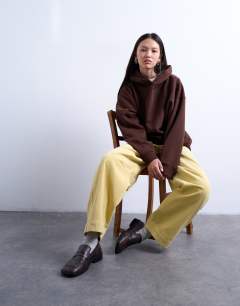 Model wearing Cord high rise barrel trouser in buttermilk