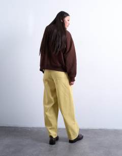 Model wearing Cord high rise barrel trouser in buttermilk