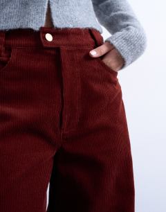 Model wearing Cord high rise barrel trouser in rust