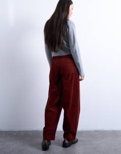 Model wearing Cord high rise barrel trouser in rust