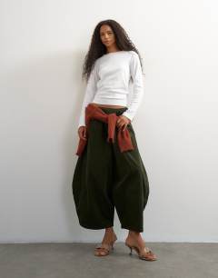 Model wearing Cord mid length ovoid trouser in green