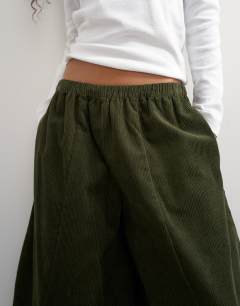 Model wearing Cord mid length ovoid trouser in green