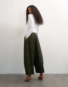 Model wearing Cord mid length ovoid trouser in green