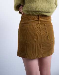 Model wearing Cord mini pelmet skirt in honey