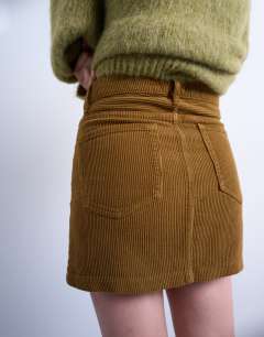 Model wearing Cord mini pelmet skirt in honey