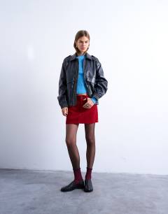 Model wearing Cord mini pelmet skirt in red