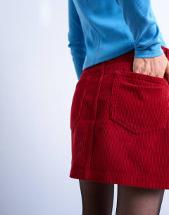 Model wearing Cord mini pelmet skirt in red