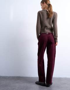 Model wearing Cord slouchy low slung trouser in burgundy