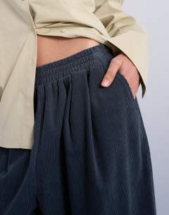 Model wearing Cord wide leg awkward length trouser in slate