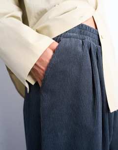 Model wearing Cord wide leg awkward length trouser in slate