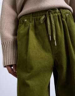 Model wearing Cord wide leg trouser with drawcord in green