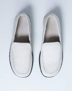 Model wearing Corrie flat shoe loafer in off white hair on real leather