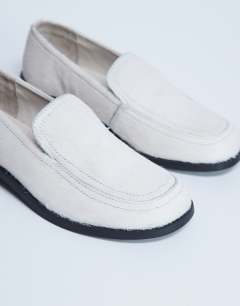 Model wearing Corrie flat shoe loafer in off white hair on real leather