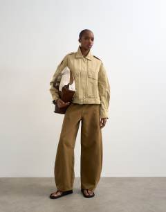 Model wearing Cotton belted biker jacket in stone