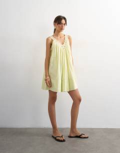 Model wearing Cotton deep v lace trapeze mini dress in washed lime