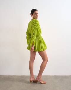 Model wearing Cotton long sleeved deep plunge bubble hem mini dress in lime
