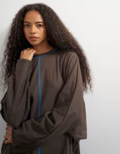 Model wearing Cotton rich rolled sleeve mini dress with blue contrast topstitching in chocolate