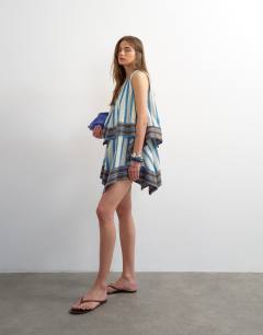 Model wearing Cotton v neck smock mini dress in contrast lime and blue stripe