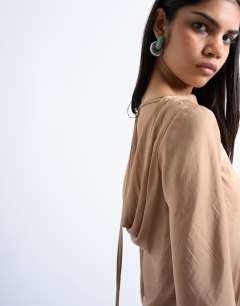 Model wearing Cowl back long sleeve mini satin in caramel