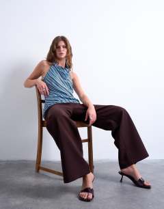 Model wearing Cowl neck halter top in blue and brown stripe
