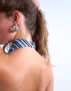 Model wearing Cowl neck halter top in blue and brown stripe