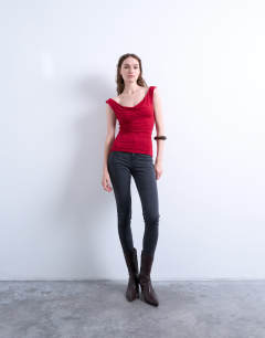 Model wearing Cowl neck tank top in red
