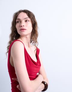 Model wearing Cowl neck tank top in red