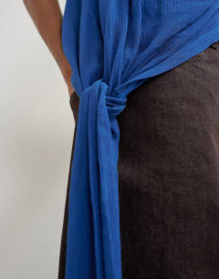 Model wearing Cowl neck tie knot drape top in colbalt blue