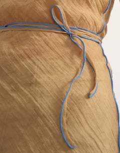 Model wearing Crinkle halter top with contrast trim in taupe