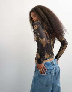 Model wearing Crinkle mesh print asymmetric neck long sleeve top in black