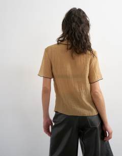 Model wearing Crinkle polo shirt with black tipping in mocha