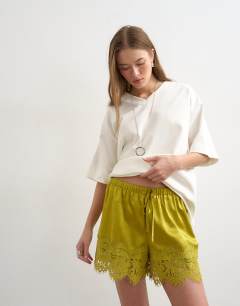 Model wearing Crinkle satin a-line mini short with lace trim in chartreuse 