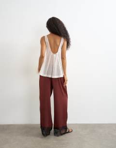 Model wearing Crinkle satin lace insert trouser in burgundy