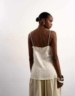 Model wearing Crinkle satin top with lace inserts in ivory