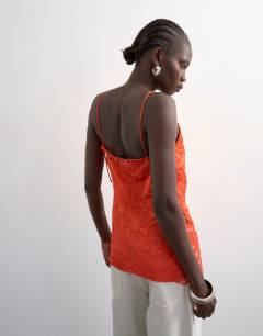 Model wearing Crinkle satin top with lace inserts in rust