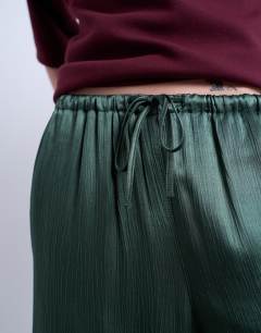 Model wearing Crinkle satin wide leg trouser in green