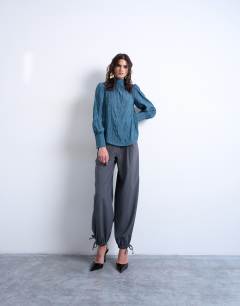 Model wearing Crinkle scarf blouse in blue