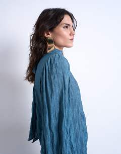 Model wearing Crinkle scarf blouse in blue