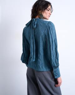 Model wearing Crinkle scarf blouse in blue