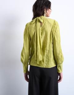 Model wearing Crinkle scarf blouse in green