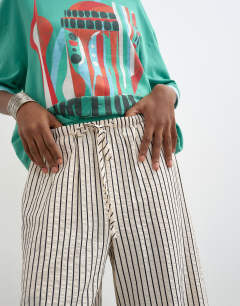 Model wearing Crinkle stripe drawcord trouser in mono